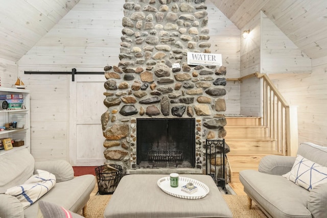 2821 Lakeshore Rd, Lexington, MI 48450 - living room with a barn door, wooden ceiling, wooden walls, high vaulted ceiling, and a fireplace