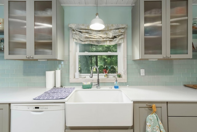 2821 Lakeshore Rd, Lexington, MI 48450 - kitchen featuring white dishwasher, light countertops, decorative backsplash, pendant lighting, and glass insert cabinets