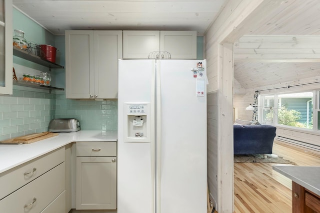 2821 Lakeshore Rd, Lexington, MI 48450 - kitchen with white fridge with ice dispenser, light wood-type flooring, light countertops, backsplash, and open shelves