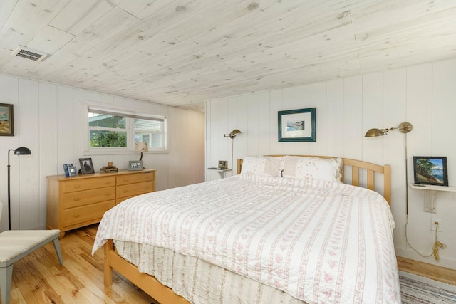 2821 Lakeshore Rd, Lexington, MI 48450 - bedroom with light wood-type flooring, wood ceiling, and wood walls