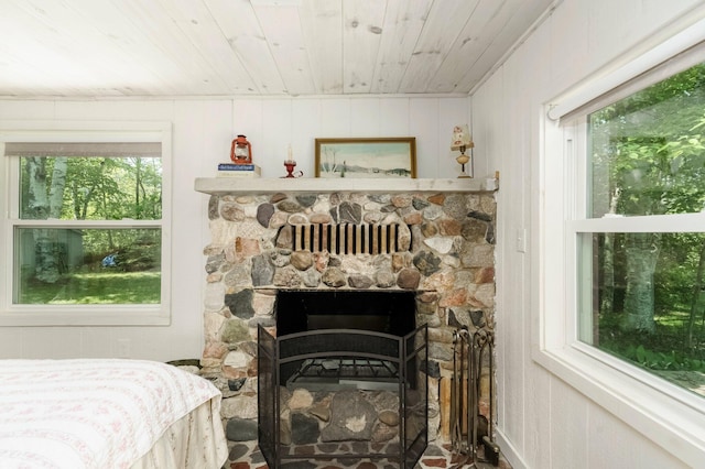2821 Lakeshore Rd, Lexington, MI 48450 - bedroom with multiple windows, wood ceiling, and a fireplace