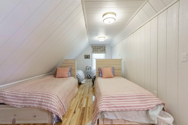 2821 Lakeshore Rd, Lexington, MI 48450 - bedroom featuring hardwood / wood-style floors, lofted ceiling, and wooden walls