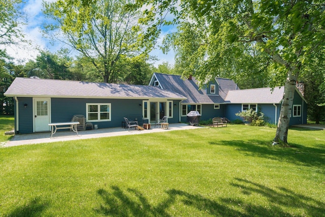 2821 Lakeshore Rd, Lexington, MI 48450 - rear view of house featuring a lawn and a patio area