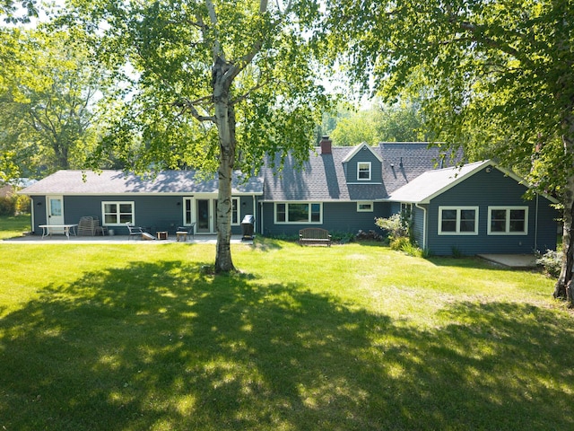 2821 Lakeshore Rd, Lexington, MI 48450 - back of house with a patio, a yard, and a chimney