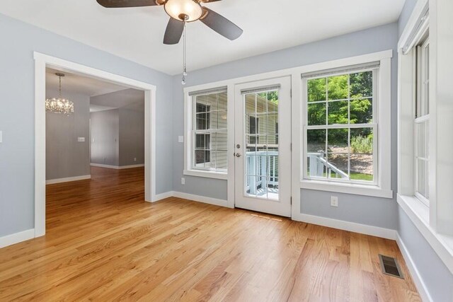 450 Carefree Ct, Niles, MI 49120 - doorway to outside featuring light wood-style floors, ceiling fan, and a chandelier