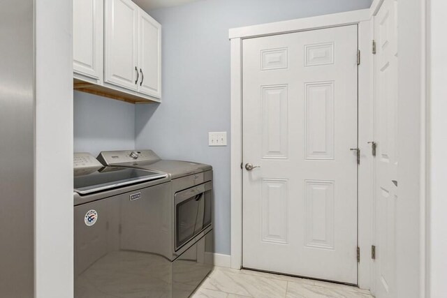 450 Carefree Ct, Niles, MI 49120 - laundry room with washer and dryer, cabinet space, and light marble finish floors