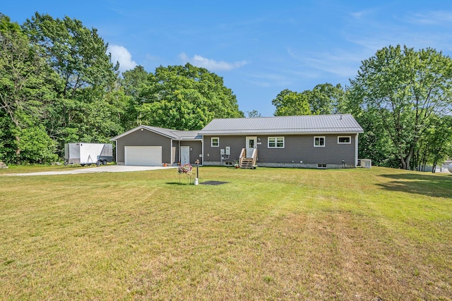 2480 S 148th Ave, Hesperia, MI 49421 - single story home featuring concrete driveway, a garage, a metal roof, and a front lawn