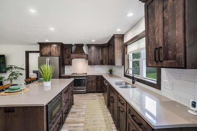2480 S 148th Ave, Hesperia, MI 49421 - kitchen featuring custom range hood, appliances with stainless steel finishes, dark brown cabinetry, a center island, and light countertops
