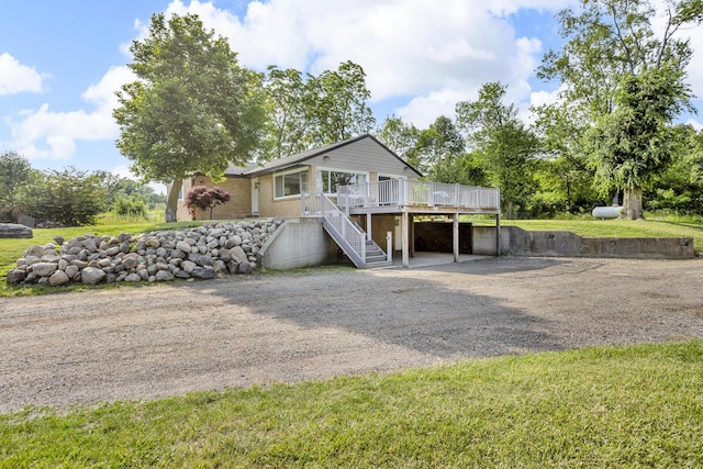 2200 Lindsey Rd, Jackson, MI 49201 - view of front of home with dirt driveway, a wooden deck, and stairs