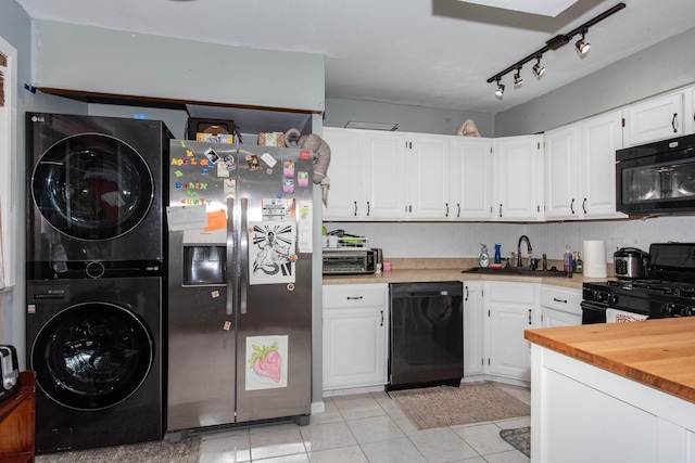 724 Garland Cir Unit D, Kalamazoo, MI 49008 - kitchen with black appliances, stacked washer and clothes dryer, white cabinets, light tile patterned flooring, and butcher block counters