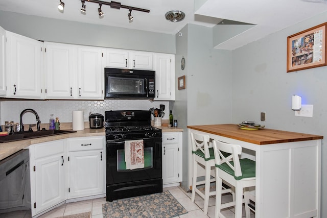 724 Garland Cir Unit D, Kalamazoo, MI 49008 - kitchen with black appliances, light tile patterned floors, and white cabinets