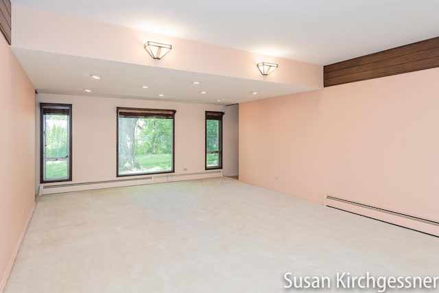 1129 Idema Dr SE, Grand Rapids, MI 49506 - spare room featuring light colored carpet, recessed lighting, and a baseboard radiator