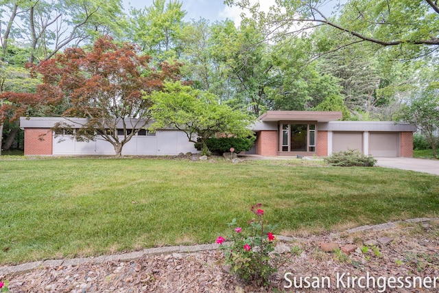 1129 Idema Dr SE, Grand Rapids, MI 49506 - view of green lawn with an attached garage and concrete driveway