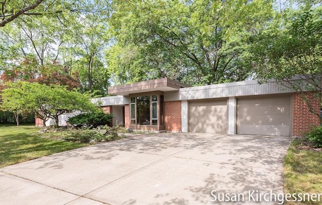 1129 Idema Dr SE, Grand Rapids, MI 49506 - view of front of property featuring brick siding, an attached garage, concrete driveway, and a front lawn