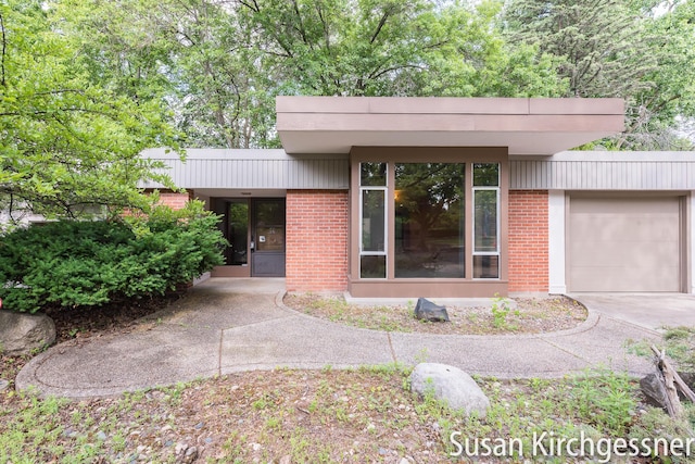 1129 Idema Dr SE, Grand Rapids, MI 49506 - view of front of home featuring brick siding, an attached garage, and concrete driveway
