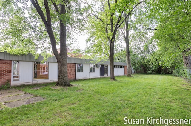 1129 Idema Dr SE, Grand Rapids, MI 49506 - view of green lawn featuring an attached garage