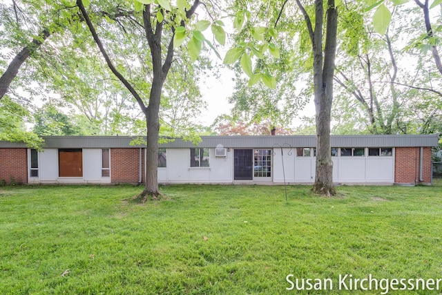 1129 Idema Dr SE, Grand Rapids, MI 49506 - rear view of property featuring a lawn and brick siding