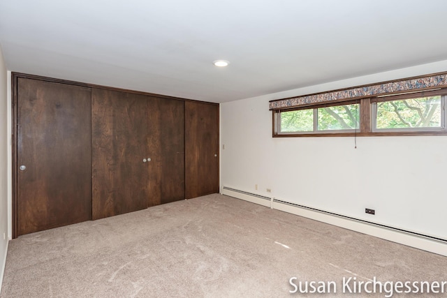 1129 Idema Dr SE, Grand Rapids, MI 49506 - unfurnished bedroom with baseboard heating, carpet, recessed lighting, and a closet