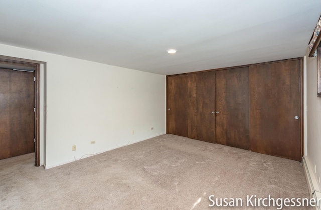 1129 Idema Dr SE, Grand Rapids, MI 49506 - unfurnished bedroom featuring carpet and a baseboard heating unit