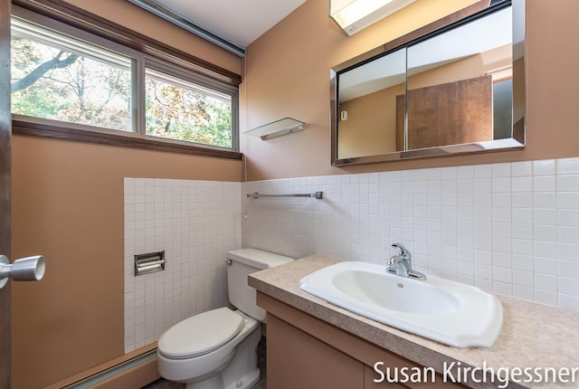 1129 Idema Dr SE, Grand Rapids, MI 49506 - half bath with baseboard heating, tile walls, and vanity
