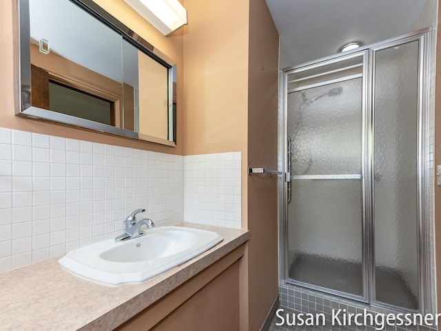 1129 Idema Dr SE, Grand Rapids, MI 49506 - bathroom featuring backsplash, a shower stall, and vanity