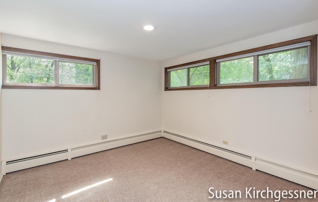 1129 Idema Dr SE, Grand Rapids, MI 49506 - carpeted empty room featuring plenty of natural light, a baseboard heating unit, and recessed lighting