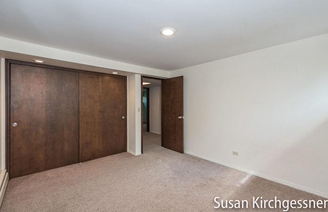 1129 Idema Dr SE, Grand Rapids, MI 49506 - unfurnished bedroom with light colored carpet, a closet, recessed lighting, and baseboard heating