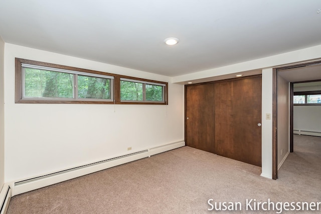 1129 Idema Dr SE, Grand Rapids, MI 49506 - unfurnished bedroom with carpet flooring, a closet, a baseboard radiator, and recessed lighting