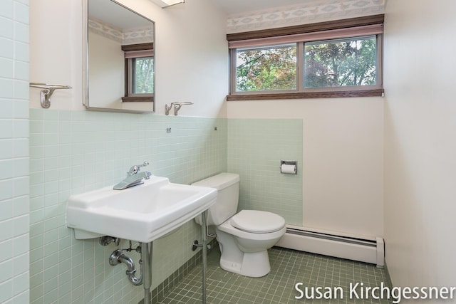 1129 Idema Dr SE, Grand Rapids, MI 49506 - bathroom featuring a baseboard heating unit, tile walls, tile patterned floors, and a wainscoted wall