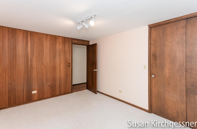 1129 Idema Dr SE, Grand Rapids, MI 49506 - unfurnished bedroom featuring carpet flooring, track lighting, and a closet