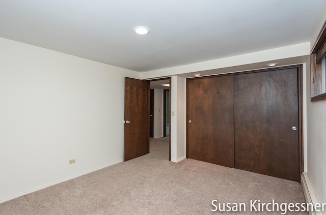 1129 Idema Dr SE, Grand Rapids, MI 49506 - unfurnished bedroom with carpet, a baseboard heating unit, recessed lighting, and a closet