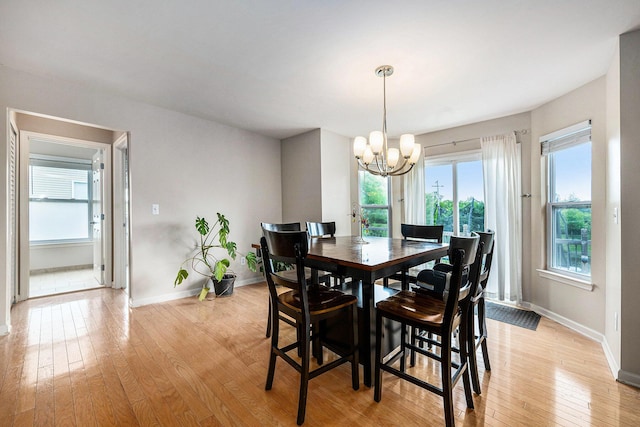 1735 Savannah Ln, Ypsilanti, MI 48198 - dining room with light wood-style floors, a chandelier, and healthy amount of natural light