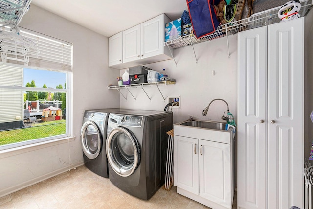 1735 Savannah Ln, Ypsilanti, MI 48198 - washroom featuring independent washer and dryer, cabinet space, and light floors