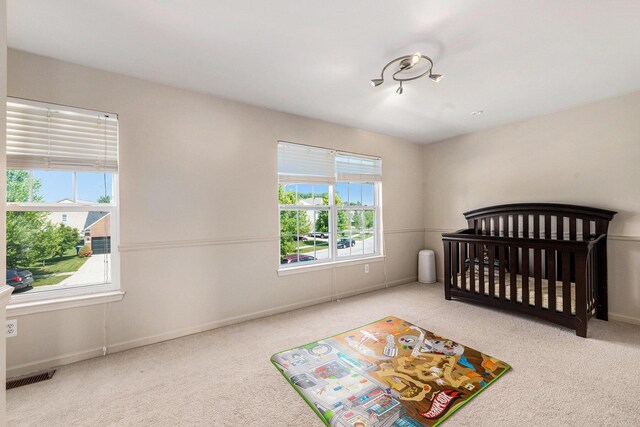 1735 Savannah Ln, Ypsilanti, MI 48198 - carpeted bedroom with multiple windows and a nursery area