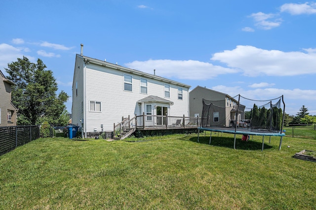 1735 Savannah Ln, Ypsilanti, MI 48198 - back of property with a trampoline and a wooden deck