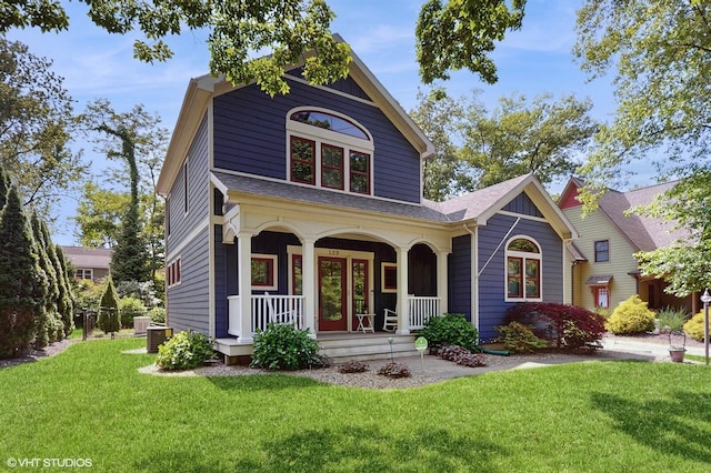 120 S Kenzie St, New Buffalo, MI 49117 - view of front of house with a porch, a front lawn, and a shingled roof