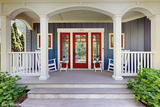 120 S Kenzie St, New Buffalo, MI 49117 - view of exterior entry with covered porch and board and batten siding