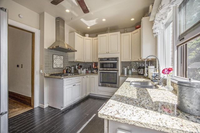 73640 Fulton St, Armada, MI 48005 - kitchen with wall chimney range hood, appliances with stainless steel finishes, ceiling fan, backsplash, and recessed lighting