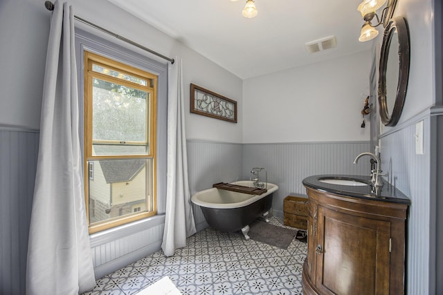 73640 Fulton St, Armada, MI 48005 - bathroom featuring wainscoting, a soaking tub, vanity, and tile patterned floors