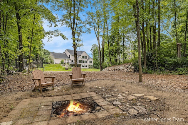 8069 Ella Terrace Ct, Rockford, MI 49341 - view of patio / terrace with an outdoor fire pit and a trampoline