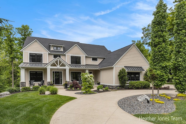 8069 Ella Terrace Ct, Rockford, MI 49341 - view of front of home with a standing seam roof, board and batten siding, a metal roof, and a front yard
