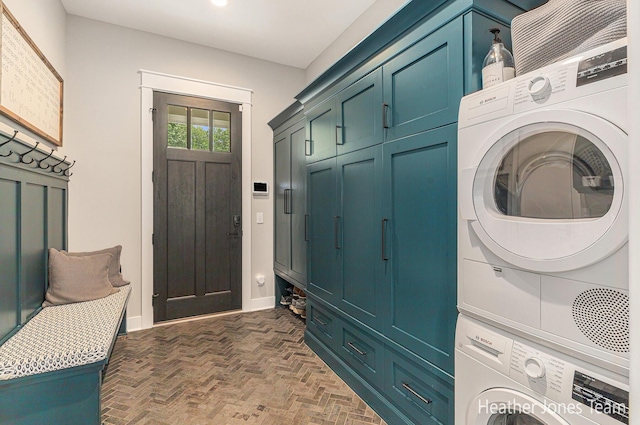 8069 Ella Terrace Ct, Rockford, MI 49341 - washroom featuring stacked washer / dryer, brick floors, and cabinet space