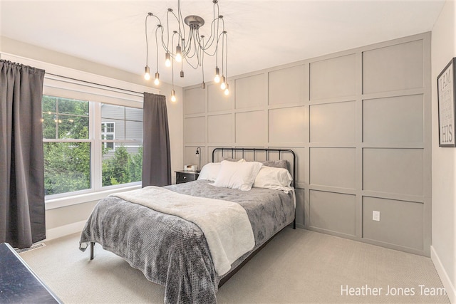 8069 Ella Terrace Ct, Rockford, MI 49341 - bedroom featuring a decorative wall, light carpet, and a chandelier