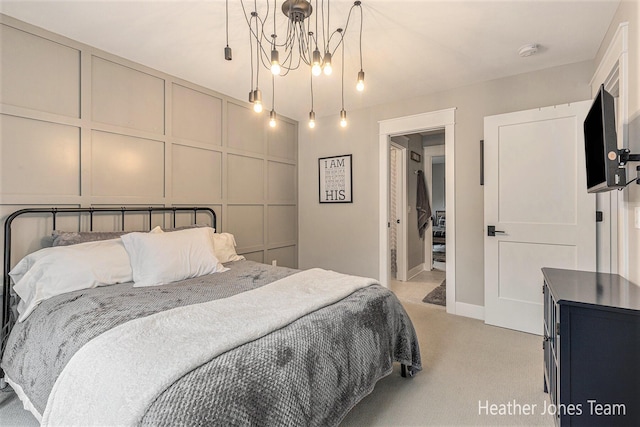 8069 Ella Terrace Ct, Rockford, MI 49341 - bedroom with light carpet, a chandelier, and a decorative wall
