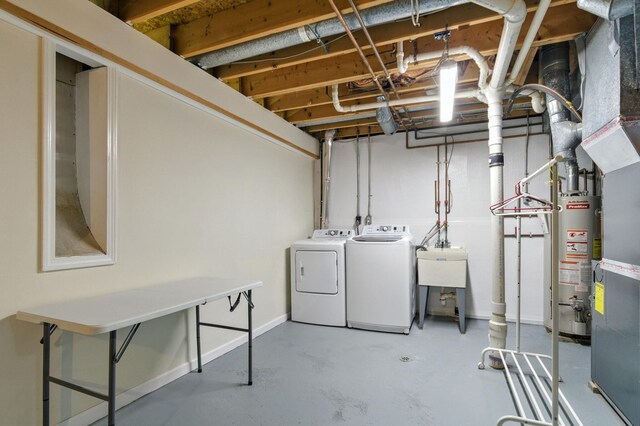 749 Foxboro Ct, Saline, MI 48176 - unfinished below grade area featuring washing machine and clothes dryer and gas water heater