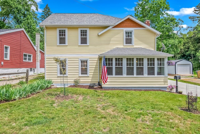 65 Salem St, Hillsdale, MI 49242 - back of property with an outdoor structure, a chimney, a detached garage, and a shingled roof
