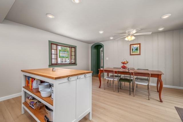 65 Salem St, Hillsdale, MI 49242 - kitchen with butcher block countertops, arched walkways, open shelves, a ceiling fan, and light wood finished floors