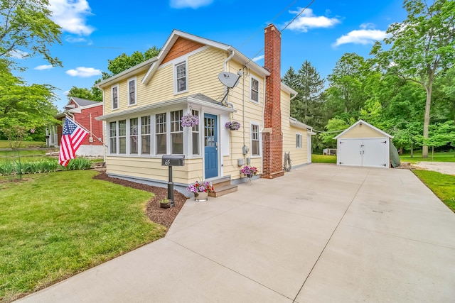 65 Salem St, Hillsdale, MI 49242 - traditional-style home with a chimney, entry steps, a front lawn, an outdoor structure, and concrete driveway
