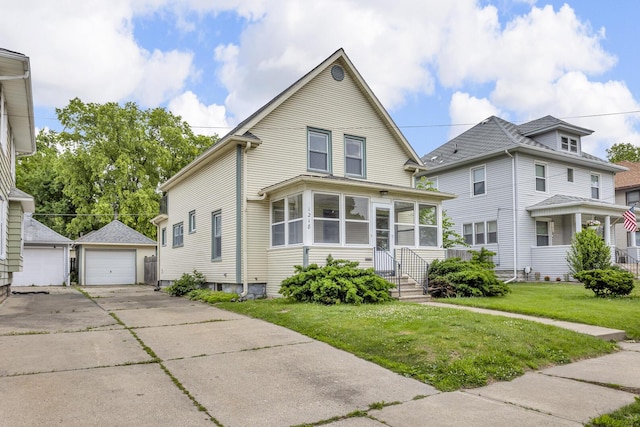 1218 Forest Ave, Jackson, MI 49201 - view of front facade featuring an outdoor structure, a front lawn, and a garage