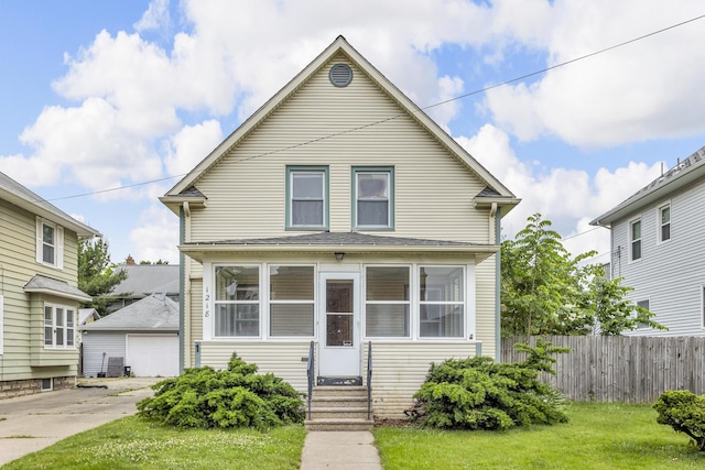 1218 Forest Ave, Jackson, MI 49201 - view of front facade featuring entry steps, an outbuilding, and a detached garage